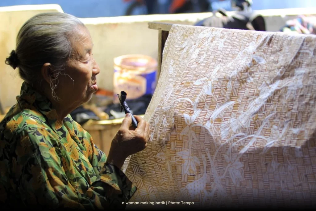 a woman making batik
