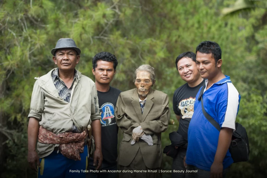 Family Take Photo with Ancestor during Mane'ne Ritual